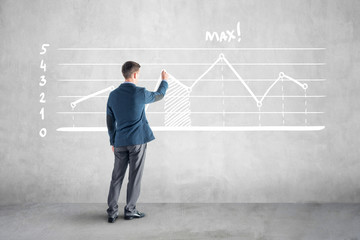 businessman drawind growth chart and arrow on the wall