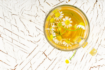 Herbal tea with fresh chamomile flowers