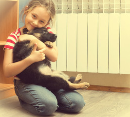 beautiful little girl and a German Shepherd puppy