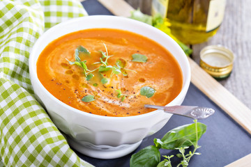 Tomato soup in white bowl
