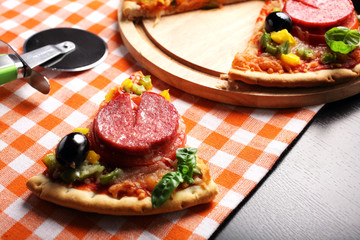 Pizza with tomato, salami, olives and basil