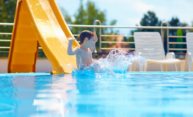cute boy kid having fun on water slide