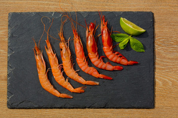 Organic Tiger shrimps on black stone background