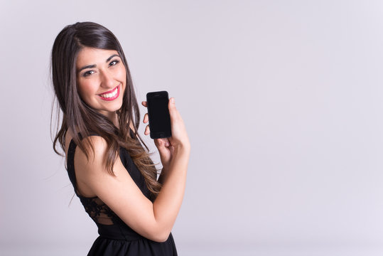 Beautiful woman smiling looking in camera with mobile phone