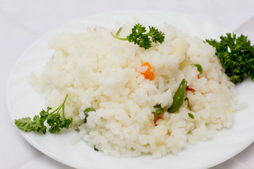 Plate full of rice on white