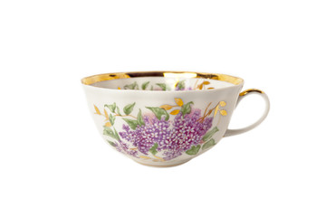 Porcelain teacup with floral ornament on white
