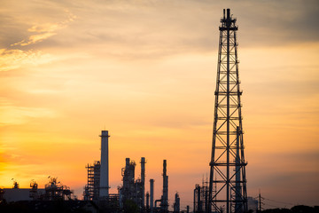 silhouette shot of refinery fire gas torch in sunset