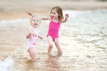 Two little sisters having fun on a beach © MNStudio