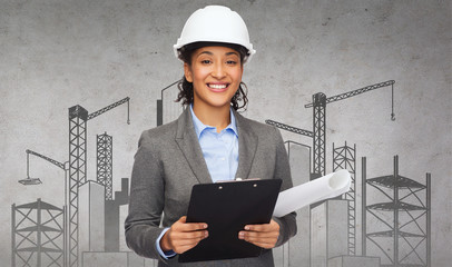 businesswoman in white helmet with clipboard