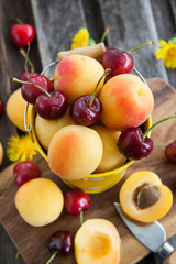 Fresh apricot and cherry in a bucket
