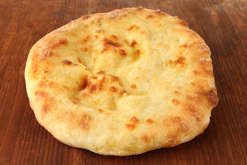 Pita bread on wooden background