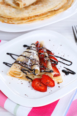 Delicious pancake with strawberries and chocolate