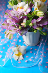 Bouquet of freesias in pail on table close-up