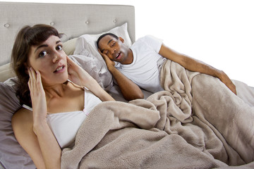 unable to sleep in bed because of snoring partner