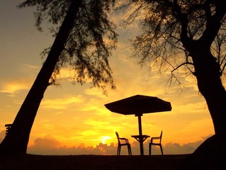 restaurant table on beach at sunrise