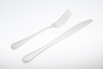 a silver fork with knife isolated on white background