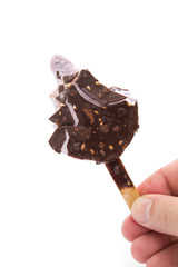 hand holding a chocolate ice cream with the last bit