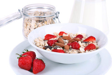 Healthy cereal in bowl with milk and strawberries closeup