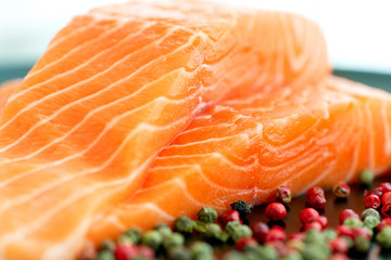 Raw salmon ready to cook close up on black surface