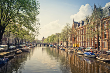 Beautiful view of Amsterdam canals with bridge and typical dutch