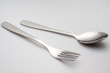 a silver fork with spoon isolated on gray background