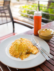 Food, omelet on rice on a wood table