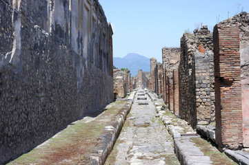 Fototapeta na wymiar Street in Pompeii ruins near volcano Vesuvius, Italy