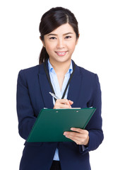 Businesswoman write on clipboard