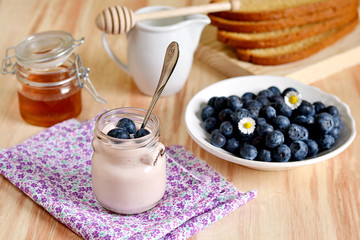 Breakfast with blueberries, honey and yogurt