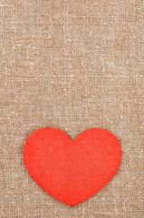 Felt red heart on the burlap