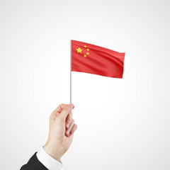 hand holding flag of China