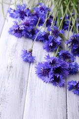 Beautiful cornflowers on wooden background