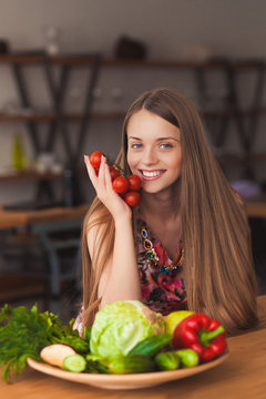 beautiful smiling girl holding vegetables in her hands