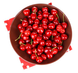 Sweet cherry on color plate isolated on white