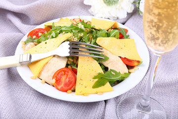 Fresh salad with arugula on fabric background