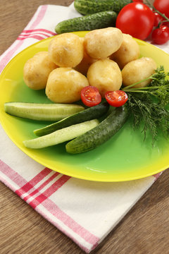 Young boiled potatoes on table, close up