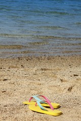 Fototapeta na wymiar Flip flops at beach