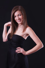 Portrait of a beautiful young woman in black dress