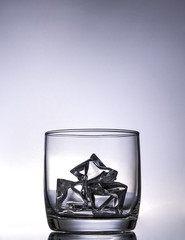 empty glas of whiskey with ice cubes