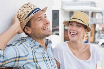 Young hip couple sitting on bench