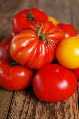 Ripe tomatoes on a old wooden table.
