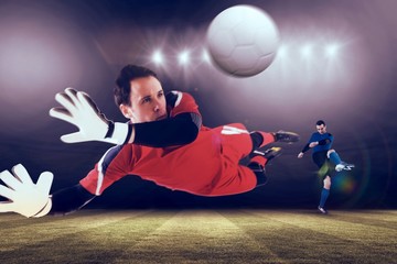 Composite image of fit goal keeper jumping up