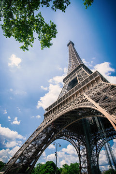 Eiffel Tower against blue cloudy sky. Paris, France.