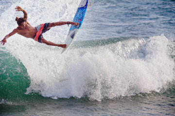 Surfer on Blue Ocean Wave in Bali