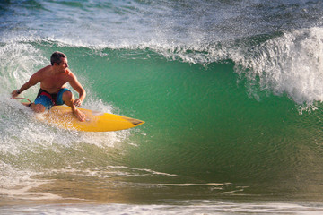 Surfer on Blue Ocean Wave in Bali