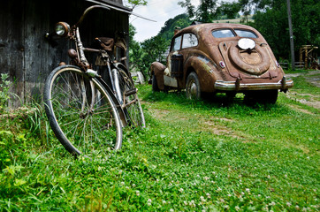 Old vintage car and bicycle in the village - 66099852