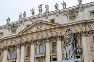 Fototapeta na wymiar Sculpture of st. Paul with the St. Peter's basilica