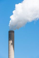 Grey chimney with white smoke