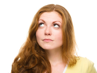 Naklejka premium Young happy woman is looking up and smile