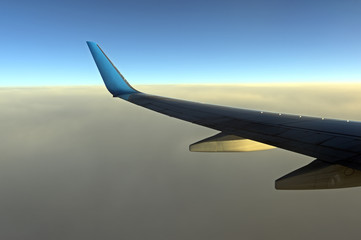 Fototapeta premium Clouds and sky as seen through window of an aircraft